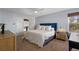 This main bedroom features a large window, ceiling fan, and ensuite bathroom at 7975 S Gaylord Way, Centennial, CO 80122