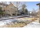 Fenced backyard with a multi-tiered deck and a stone retaining wall at 21572 E Union Dr, Aurora, CO 80015