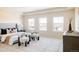 Main bedroom with large windows, stylish furniture, and neutral color palette at 21572 E Union Dr, Aurora, CO 80015