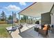 Inviting covered back patio with comfortable seating, perfect for outdoor relaxation and entertaining at 2714 S Raleigh St, Denver, CO 80236
