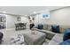 Finished basement featuring a cozy lounge area with an ottoman and TV at 2714 S Raleigh St, Denver, CO 80236