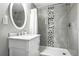 Elegant bathroom with marble vanity, decorative mirror, and modern tiled shower for a spa-like experience at 2714 S Raleigh St, Denver, CO 80236
