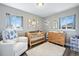 Cozy Bedroom with a wooden crib, neutral decor, and natural light at 2714 S Raleigh St, Denver, CO 80236