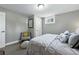 Comfortable bedroom features plush gray bedding, a cozy chair, and soft natural light at 2714 S Raleigh St, Denver, CO 80236