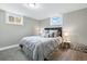 Relaxing bedroom with soft gray bedding, side tables, and cozy decor for a peaceful night's rest at 2714 S Raleigh St, Denver, CO 80236