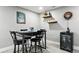Charming dining area features a modern table, wine storage, and stylish decor for memorable gatherings at 2714 S Raleigh St, Denver, CO 80236