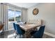 Cozy dining area with a large window, decorative clock, and tufted bench seating at 2714 S Raleigh St, Denver, CO 80236