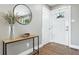 Inviting entryway with a stylish console table, modern mirror, and bright front door at 2714 S Raleigh St, Denver, CO 80236
