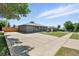 Wide driveway and gray exterior offer ample parking and a modern look at 2714 S Raleigh St, Denver, CO 80236