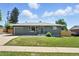 Charming home featuring well-maintained lawn, gray brick exterior, and attached garage at 2714 S Raleigh St, Denver, CO 80236