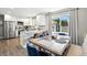 Eat-in kitchen features stainless steel appliances and adjacent dining area at 2714 S Raleigh St, Denver, CO 80236