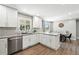 Bright eat-in kitchen features stainless steel appliances, island, and modern countertops at 2714 S Raleigh St, Denver, CO 80236