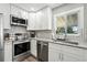 Modern kitchen featuring stainless steel appliances, white cabinets and black and white backsplash at 2714 S Raleigh St, Denver, CO 80236
