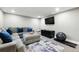 Relaxing living room with gray sectional, blue pillows, and modern entertainment setup for comfortable living at 2714 S Raleigh St, Denver, CO 80236