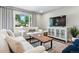 Cozy living space featuring modern furniture, large window and entertainment center at 2714 S Raleigh St, Denver, CO 80236