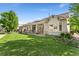 Spacious backyard features lush lawn, covered deck, and mature trees at 4932 Democrat Dr, Broomfield, CO 80023