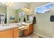 Bright bathroom features double sinks, vanity area, and two windows for natural light at 4932 Democrat Dr, Broomfield, CO 80023