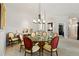 Elegant dining room with a round glass table, seating for six, and stylish chandelier at 4932 Democrat Dr, Broomfield, CO 80023