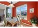 Bright dining room with a wooden table set, lots of plants, and access to the backyard at 4932 Democrat Dr, Broomfield, CO 80023