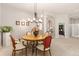 Bright dining room with hardwood table, stylish chairs, and elegant chandelier at 4932 Democrat Dr, Broomfield, CO 80023
