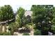 An elevated view of the exterior featuring lush, mature landscaping and a well-maintained property at 4932 Democrat Dr, Broomfield, CO 80023