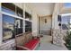 Inviting front porch with stone supports, cozy bench, and views of the surrounding neighborhood at 4932 Democrat Dr, Broomfield, CO 80023