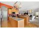 Bright kitchen featuring an island, tile countertops, and an open floor plan at 4932 Democrat Dr, Broomfield, CO 80023