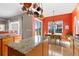 Open kitchen with a large kitchen island and a dining table near the backyard exit at 4932 Democrat Dr, Broomfield, CO 80023