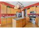 Spacious kitchen with stainless steel appliances, granite counters, and wood floors at 4932 Democrat Dr, Broomfield, CO 80023