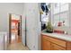 Bright laundry room with built-in cabinets and a view of the kitchen at 4932 Democrat Dr, Broomfield, CO 80023
