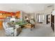 Spacious living area with comfortable furnishings, open layout, and seamless flow to the kitchen at 4932 Democrat Dr, Broomfield, CO 80023