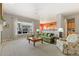 Bright and airy living room with large windows, plush seating, and an open-concept design at 4932 Democrat Dr, Broomfield, CO 80023