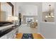 Open-concept living space with hardwood floors, fireplace, and views into adjacent rooms at 4932 Democrat Dr, Broomfield, CO 80023