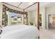Sunlit main bedroom showcasing a canopy bed, and access to a deck at 4932 Democrat Dr, Broomfield, CO 80023