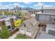An aerial view showing the home's garage, patio, and garden space with the Denver skyline at 1832 W 33Rd Ave, Denver, CO 80211