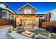 Backyard with inviting firepit, patio with pergola lighting, and manicured landscaping at 1832 W 33Rd Ave, Denver, CO 80211