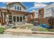Beautiful backyard featuring an outdoor kitchen, fire pit, lounge furniture, and a wooden pergola at 1832 W 33Rd Ave, Denver, CO 80211