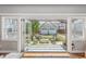 View from inside out to a beautiful backyard with artificial turf, fire pit and detached garage at 1832 W 33Rd Ave, Denver, CO 80211