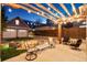 Cozy backyard patio with a charming firepit, pergola with string lights, and comfortable seating at 1832 W 33Rd Ave, Denver, CO 80211