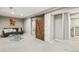 Cozy basement featuring a large sliding barn door, sectional, and glass coffee table at 1832 W 33Rd Ave, Denver, CO 80211