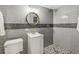 Bathroom featuring subway tile, glass shower, vanity and wood frame round mirror at 1832 W 33Rd Ave, Denver, CO 80211