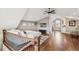 Stylish loft bedroom with hardwood floors, vaulted ceilings, and a cozy sitting area at 1832 W 33Rd Ave, Denver, CO 80211