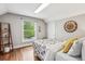 Bedroom with hardwood flooring, window, accent wall decor and closet at 1832 W 33Rd Ave, Denver, CO 80211