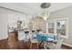 Bright dining area featuring a modern chandelier, breakfast bar, and a glimpse into a gourmet kitchen at 1832 W 33Rd Ave, Denver, CO 80211