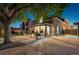 Charming exterior with covered porch, rod iron fencing, mature tree and welcoming lighting at 1832 W 33Rd Ave, Denver, CO 80211