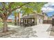 Quaint home with a fenced front patio, a lush tree, and a private driveway at 1832 W 33Rd Ave, Denver, CO 80211