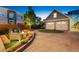 Exterior view of the home showcasing a well-manicured yard, garage, and inviting outdoor space at 1832 W 33Rd Ave, Denver, CO 80211