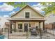 Charming home with a fenced front patio, wood porch, and freshly painted exterior at 1832 W 33Rd Ave, Denver, CO 80211