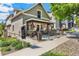 Charming exterior view shows a front porch with black iron fencing and a real estate sign at 1832 W 33Rd Ave, Denver, CO 80211