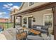 Inviting front porch featuring comfortable seating, a swing, and charming architectural details at 1832 W 33Rd Ave, Denver, CO 80211